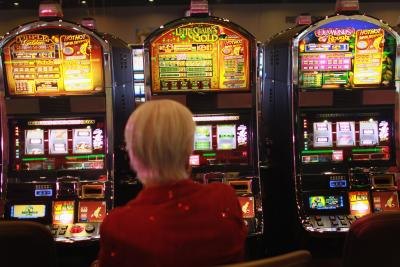 Woman trying her luck on slot machine