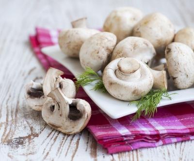 White mushrooms on a plate.