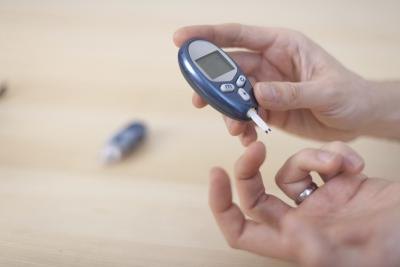 Woman taking blood sugar level test