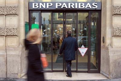 Woman walking by BNP Paribas entrance