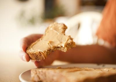 Close-up of peanut butter whole wheat toast being eaten.