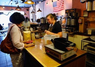 Barista helping customer at counter