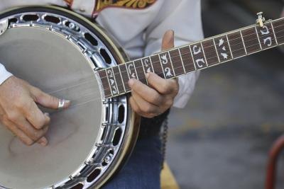 Close-up of somebody playing the banjo.