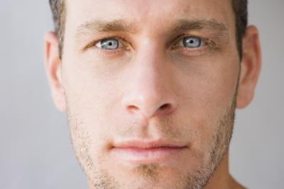 A close up of a mans face.