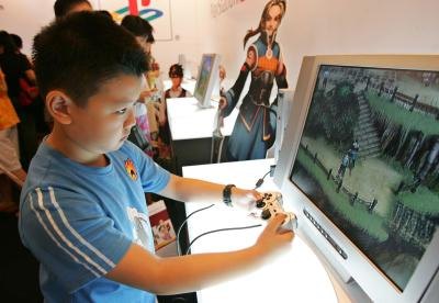 Young boy playing with PlayStation 2 game system