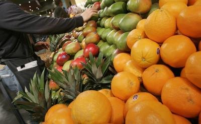 Grocer handling mangoes