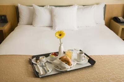 Breakfast on bed in hotel room. Breakfast on bed in hotel room.