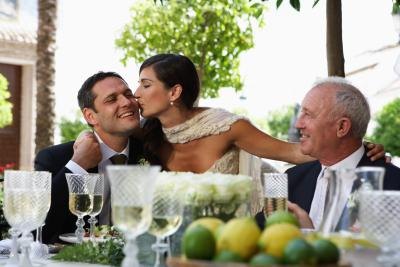 Newlywed couple with father of groom.