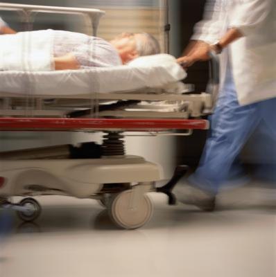 Older man being rushed through Emergency Room