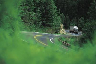 Semi truck winding through mountainous roads