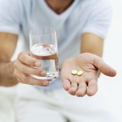 Glass of water and aspirin pills