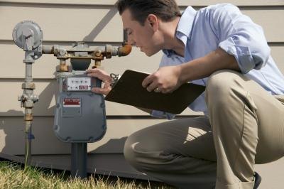 man inspecting water meter