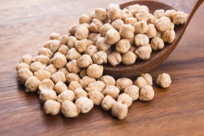 Wooden spoonful of chickpeas.