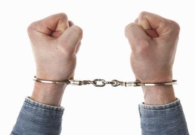 Close up of hands in handcuffs.