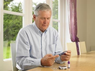 man with diabetes taking blood test