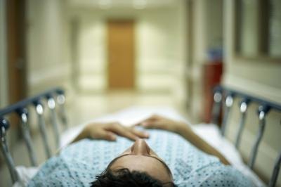 Patient lying on hospital gurney Patient lying on hospital gurney