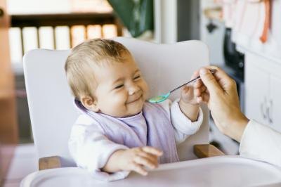 Baby smiling in highchair