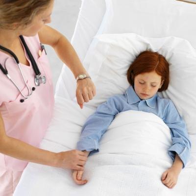 Nurse taking child's pulse