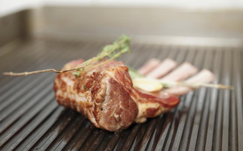 A small rack of lamb on the grill. A small rack of lamb on the grill.