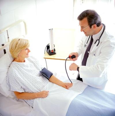 A woman has her blood pressure checked before a colonoscopy procedure.
