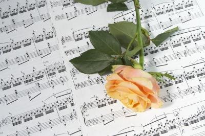 Rose on sheet music with song lyrics.