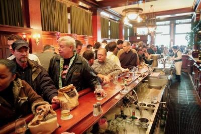 Patrons crowd inside a bar
