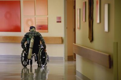 Man in wheelchair with oxygen tank