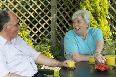 A couple enjoys breakfast together on the back patio.