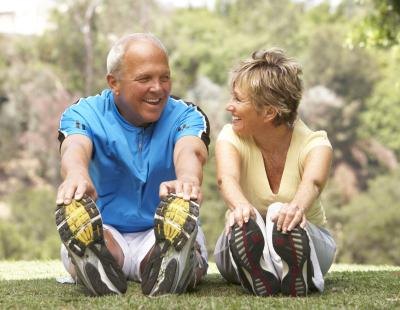 retired couple exercising and stretching