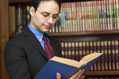 Lawyer reading from legal book