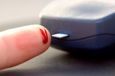 Woman testing blood sugar levels