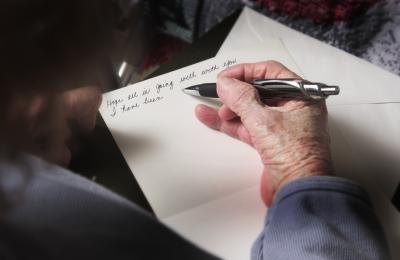 Senior citizen writing on new stationary