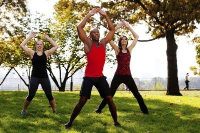Young adults doing jumping jacks to stay active and warm