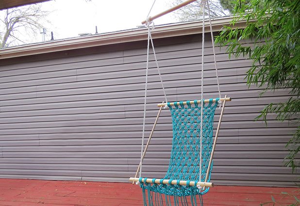 Hang the hammock from a sturdy hook and adjust the ropes.