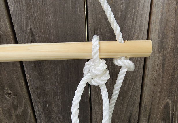 Wrap the rope around the third dowel and tie a loose knot.