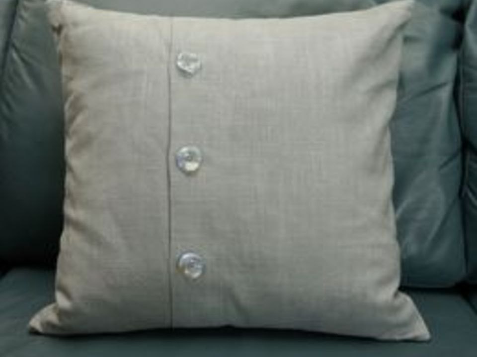 Envelope-back pillow with decorative buttons. Envelope-back pillow with decorative buttons.