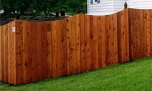 A decorative scalloped cedar fence design. A decorative scalloped cedar fence design.