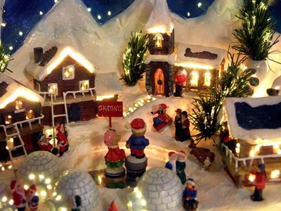 Buildings and figurines on a Christmas village platform. Buildings and figurines on a Christmas village platform.