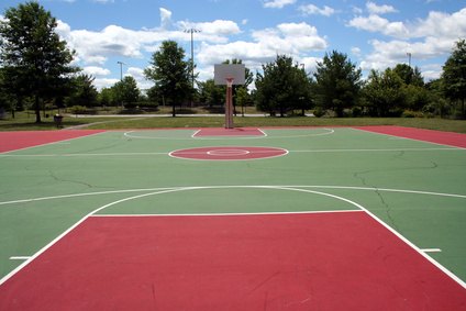 The lane on this basketball court is red. The lane on this basketball court is red.