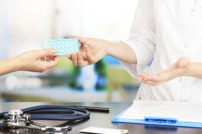 woman taking birth control pills woman taking birth control pills