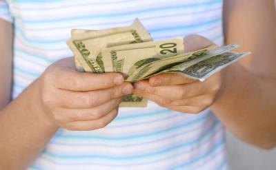 Child's hands counting money raised. Child's hands counting money raised.