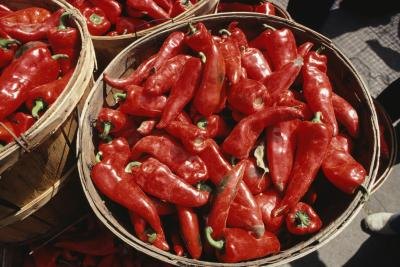 A basket filled with hot peppers. A basket filled with hot peppers.