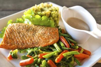 Grilled piece of salmon on dinner plate. Grilled piece of salmon on dinner plate.