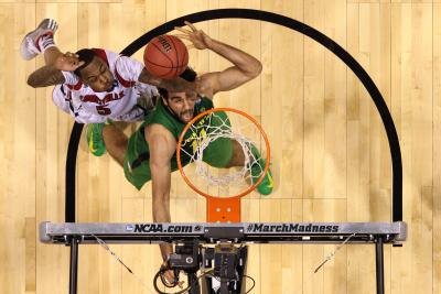 Basketball players reaching for hoop Basketball players reaching for hoop
