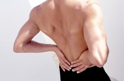 Man rubbing lower back Man rubbing lower back