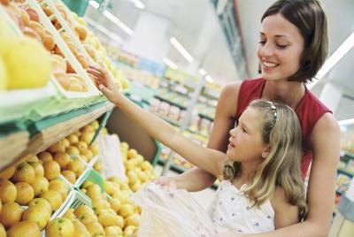 woman with daughter at grocery store woman with daughter at grocery store