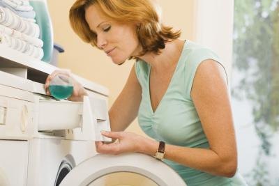 A woman using laundry detergent. A woman using laundry detergent.