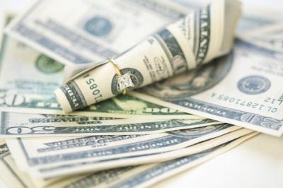 Pile of cash with wedding ring Pile of cash with wedding ring
