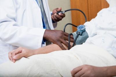 A doctor takes a patients blood pressure before a procedure. A doctor takes a patients blood pressure before a procedure.