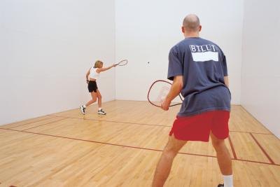 Couple playing racquetball Couple playing racquetball